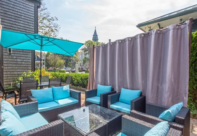 a patio with patio a table and chairs under an umbrella