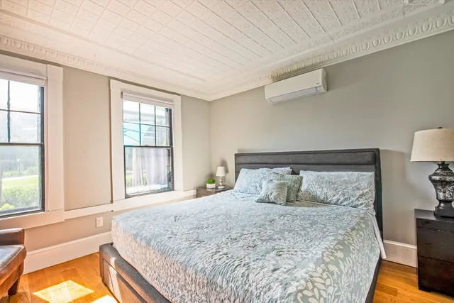 a bedroom with a large bed and a large window with outer view