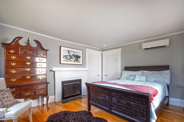 a bedroom with a bed and a fireplace