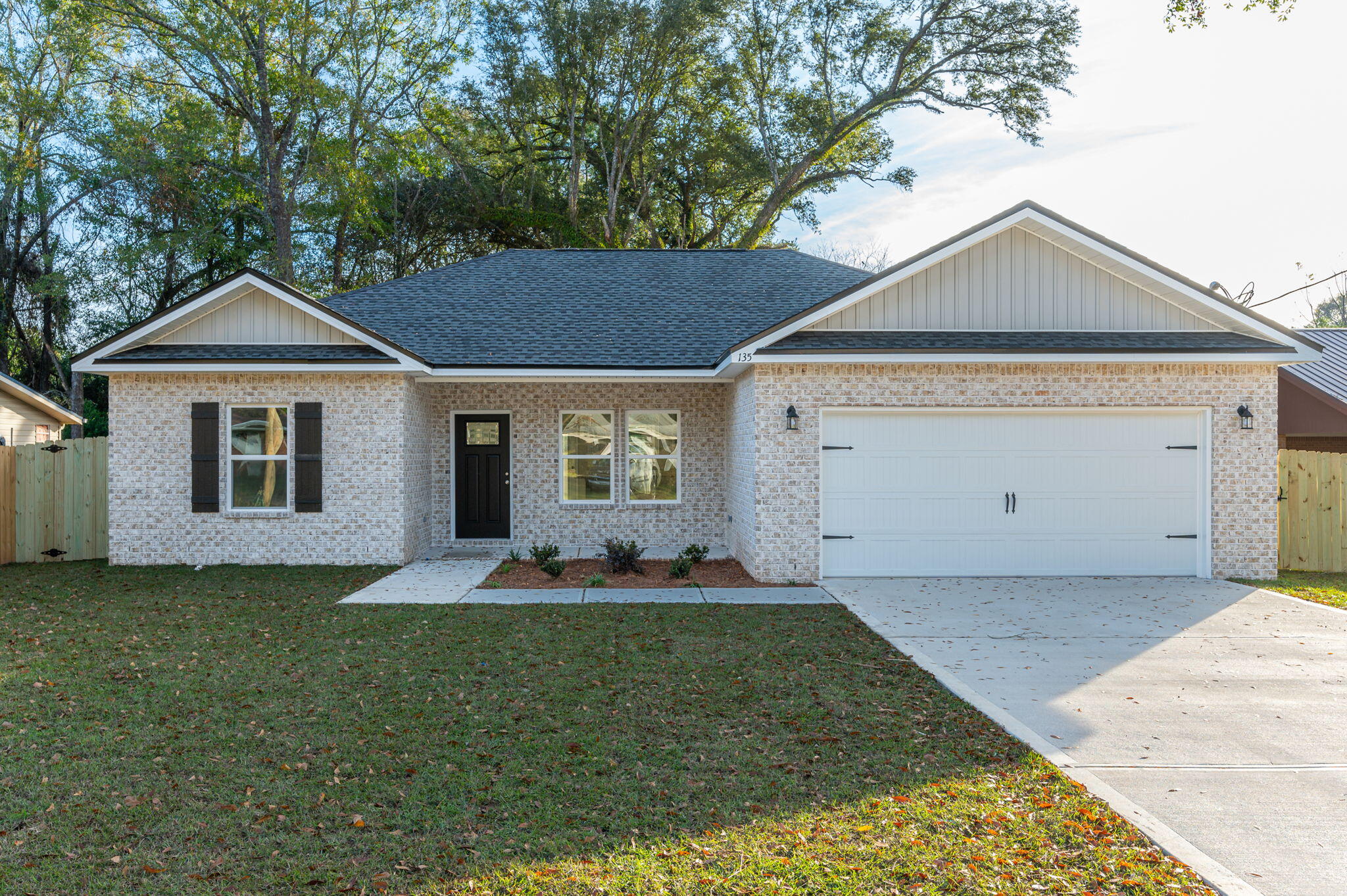6013 Sand Hill Road Crestview, FL 32539 - Photo 1 of 18 a front view of a house with a yard