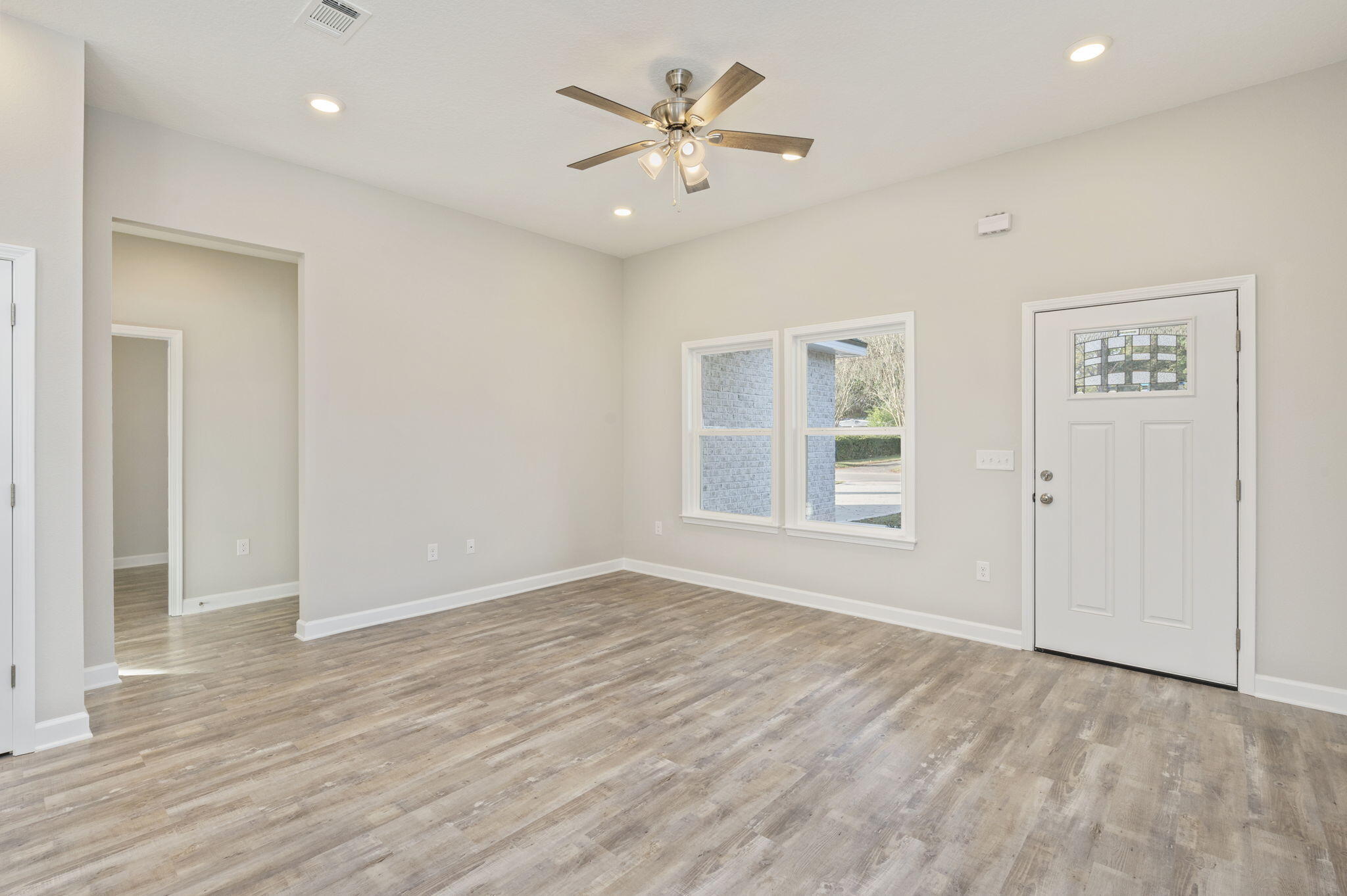 6013 Sand Hill Road Crestview, FL 32539 - Photo 4 of 18 wooden floor in an empty room with a window