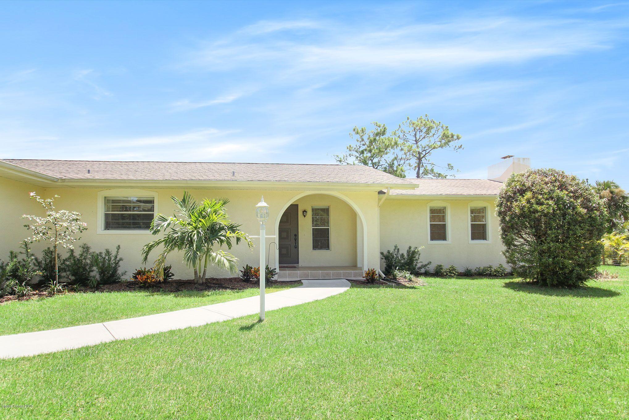 4521 Mustang Road Melbourne, FL 32934 - Photo 2 of 24 a front view of a house with garden