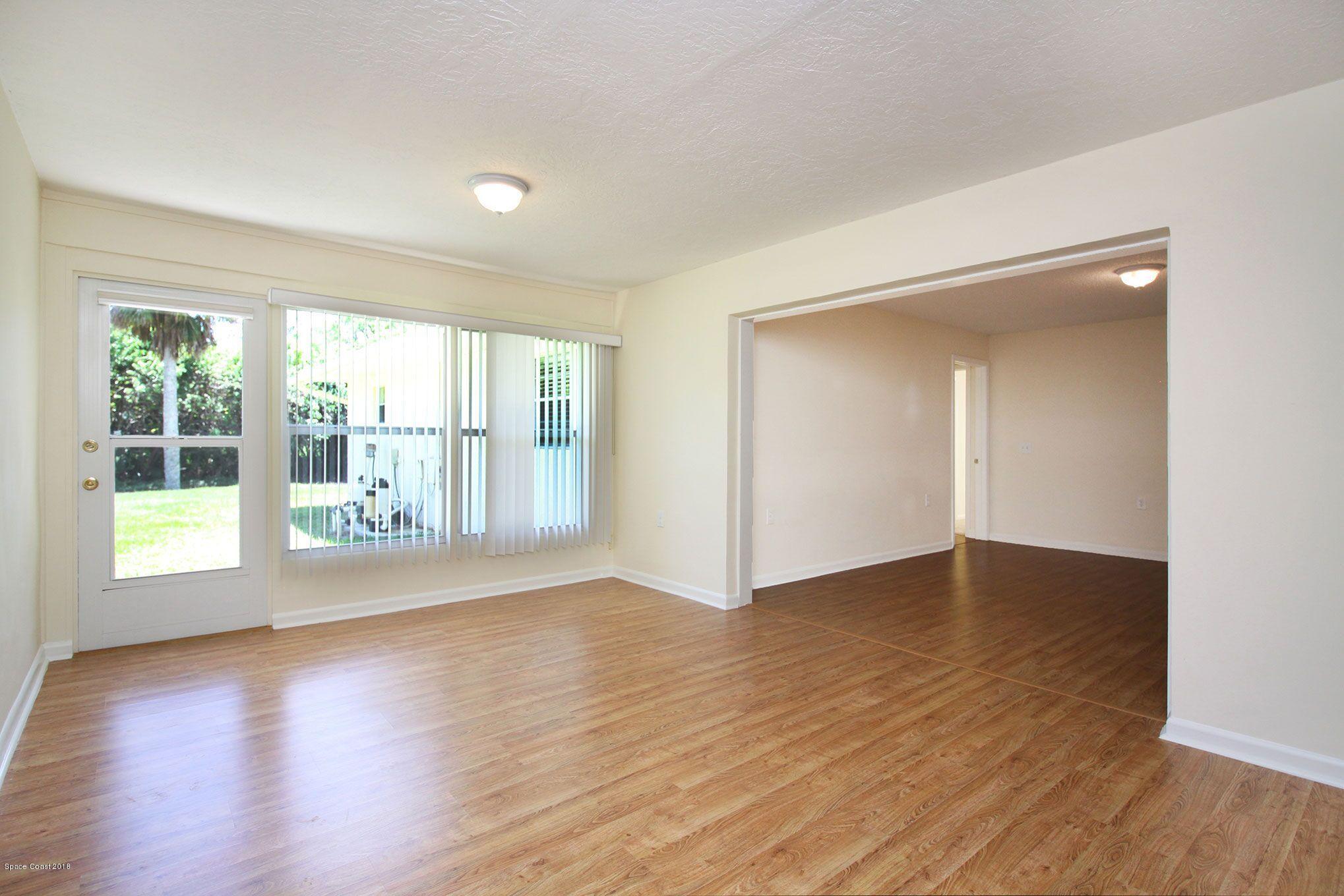 4521 Mustang Road Melbourne, FL 32934 - Photo 16 of 24 a view of an empty room with wooden floor and a window
