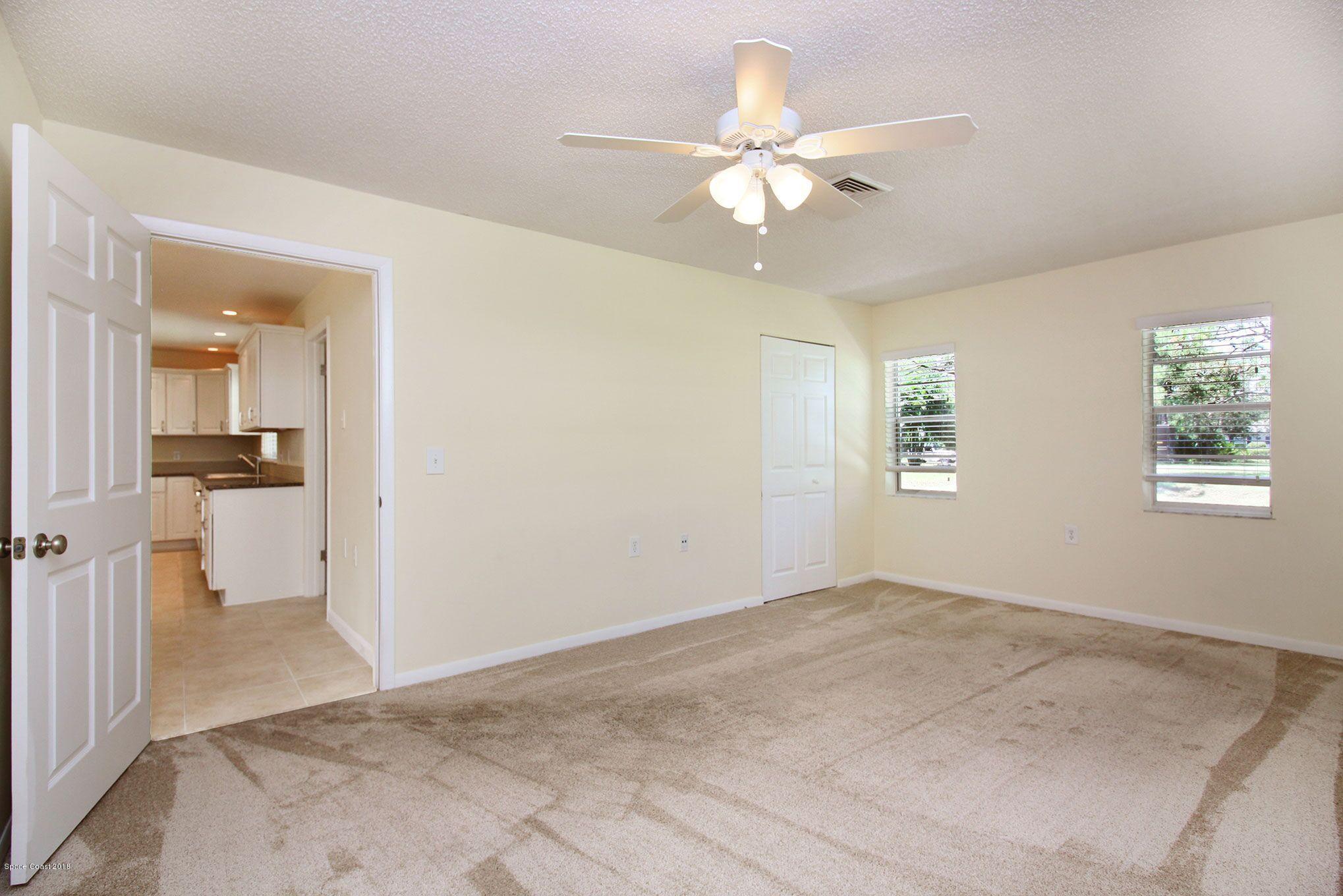 4521 Mustang Road Melbourne, FL 32934 - Photo 22 of 24 wooden floor in an empty room with a window