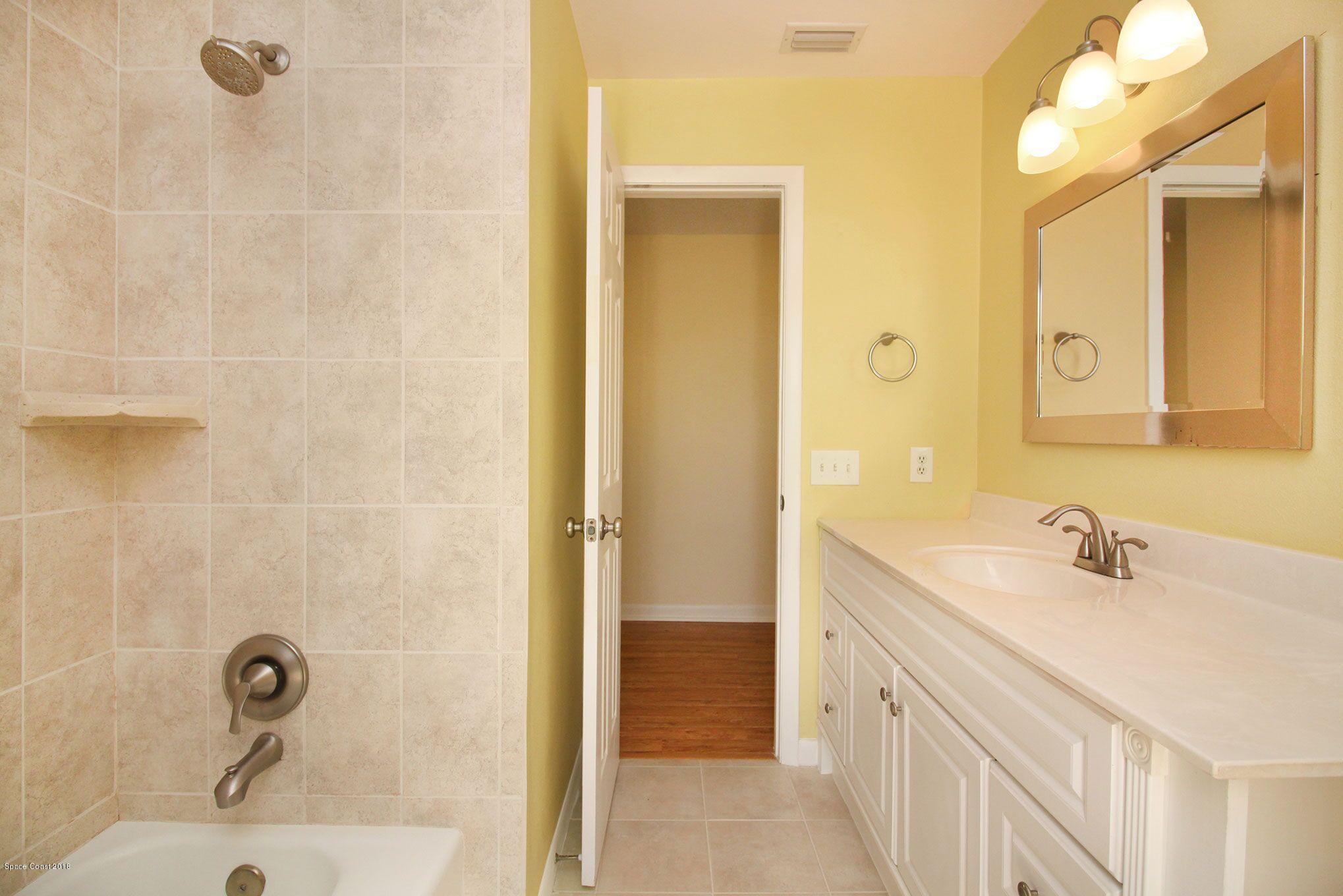 4521 Mustang Road Melbourne, FL 32934 - Photo 23 of 24 a bathroom with a sink and a mirror