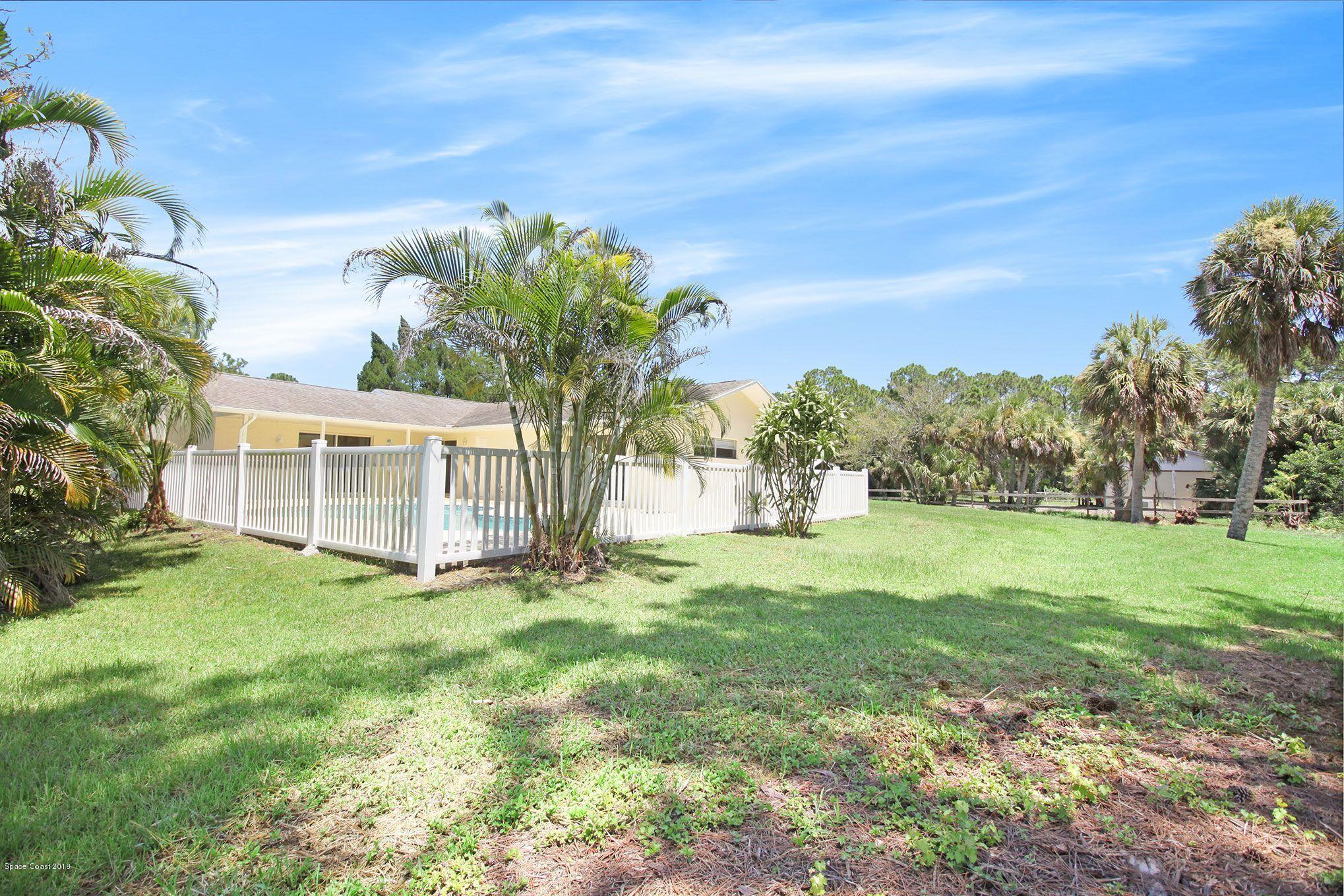 4521 Mustang Road Melbourne, FL 32934 - Photo 4 of 24 a view of a house with a big yard