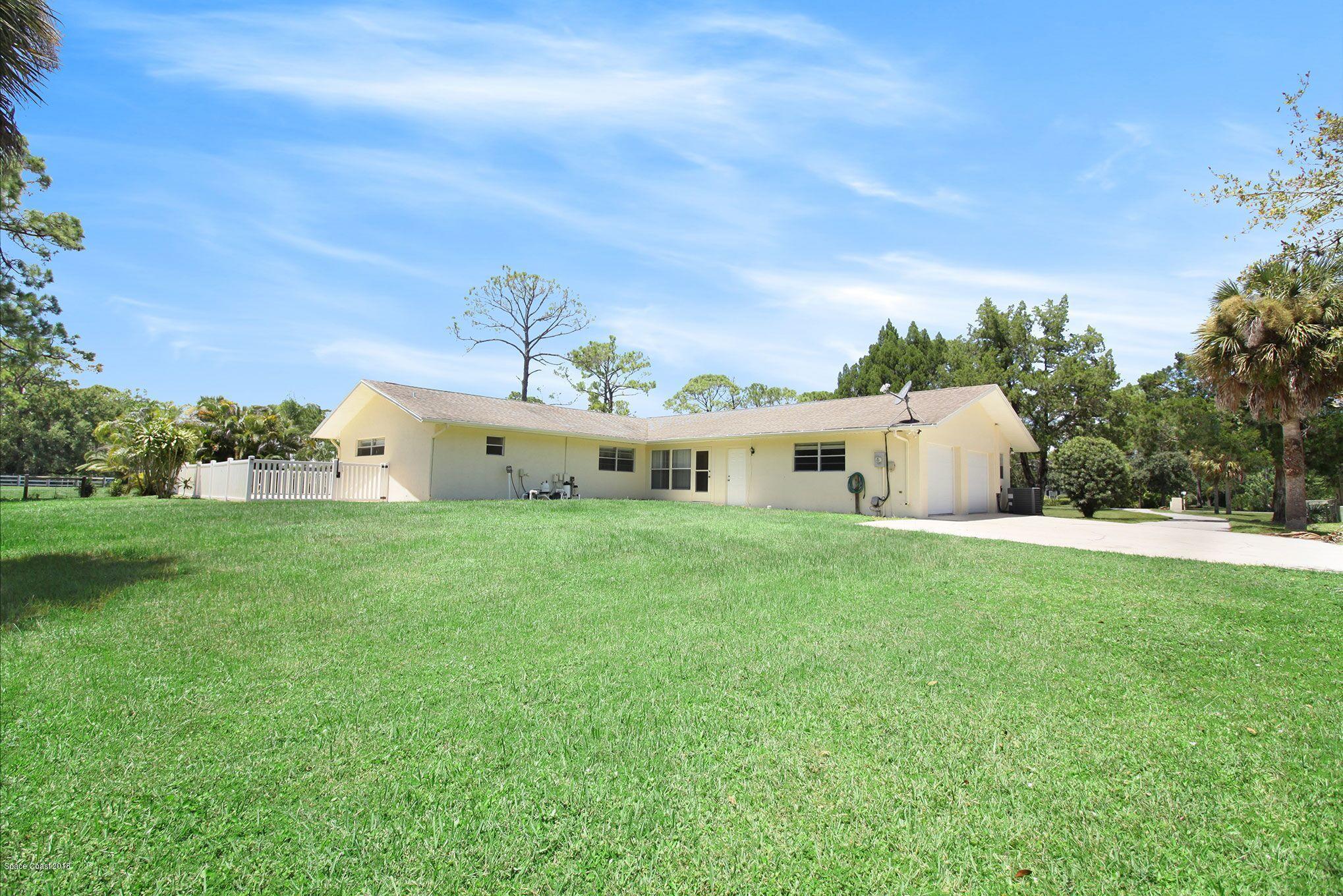 4521 Mustang Road Melbourne, FL 32934 - Photo 6 of 24 a aerial view of a house with yard and a garden