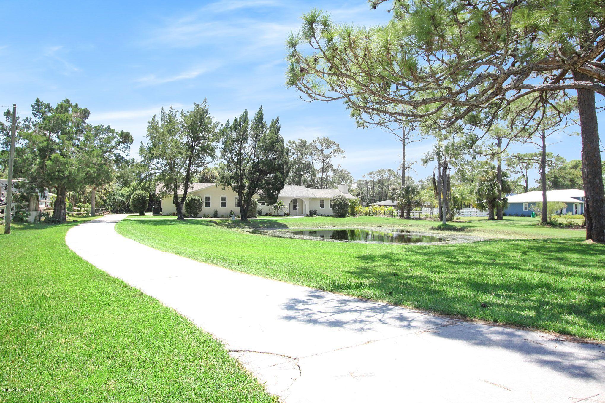 4521 Mustang Road Melbourne, FL 32934 - Photo 7 of 24 a view of a park with large trees