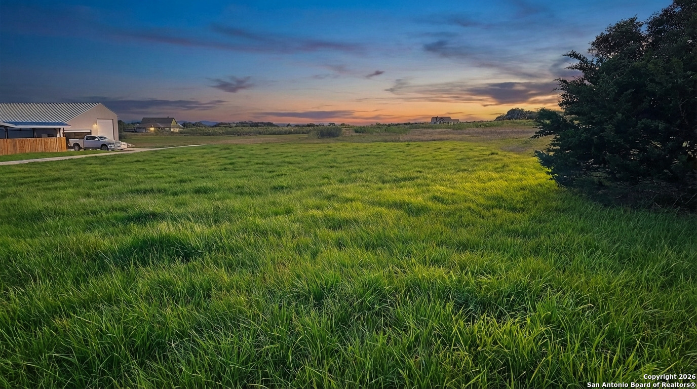 1148 Lariat Trace Bandera, TX 78003 - Photo 2 of 4 a yard with lots of green space and fog