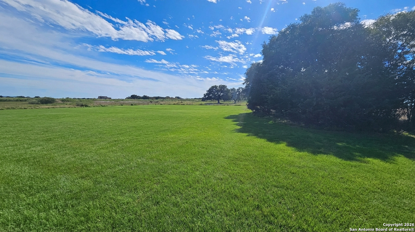 1148 Lariat Trace Bandera, TX 78003 - Photo 3 of 4 a view of a lake from a yard