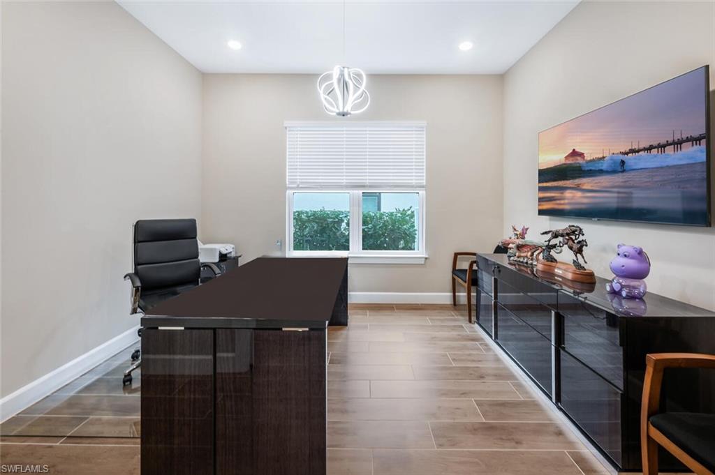 8416 Rosa Court Naples, FL 34114 - Photo 13 of 34 Room featuring wood-finish tile flooring, recessed lighting, and a modern ceiling fixture