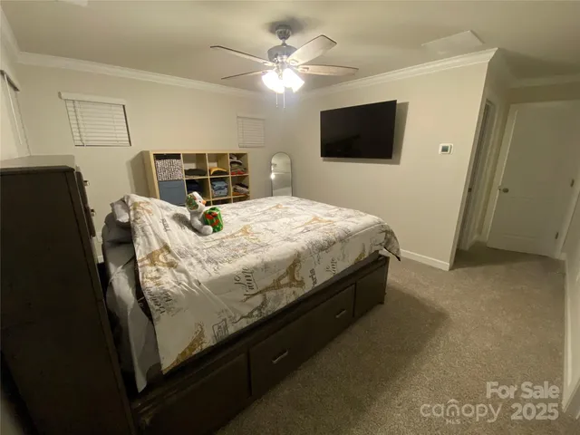a bed sitting in a bedroom and tv
