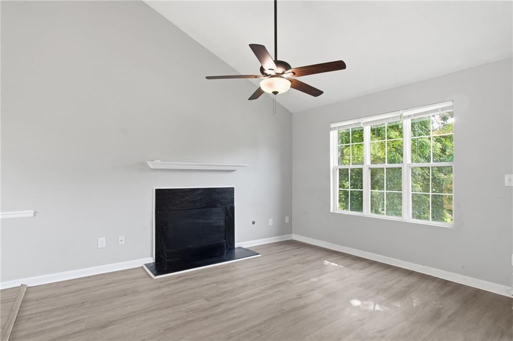5855 Crescent Ridge Court Lithonia, GA 30058 - Photo 11 of 46 an empty room with windows and fireplace
