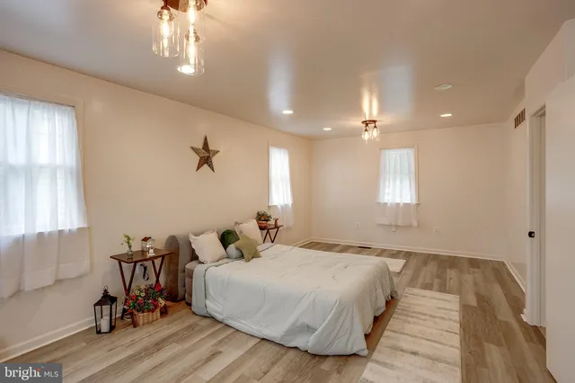 a bedroom with bed and a chandelier