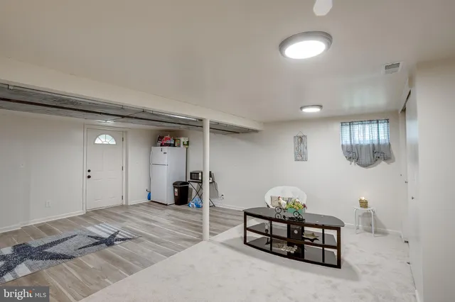 a bedroom with bed and a chandelier