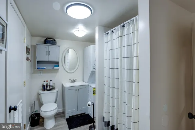 a bathroom with a sink toilet mirror and shower