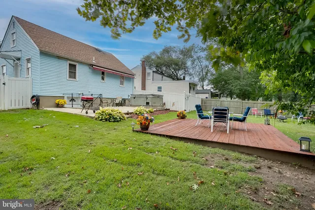 a view of a backyard with sitting area