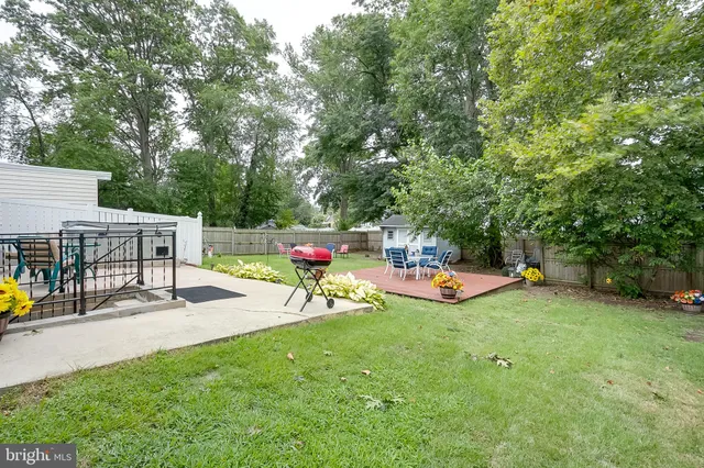 a view of a chairs and tables in the back yard