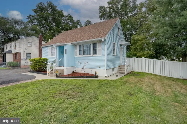 a view of a house with a yard and a porch