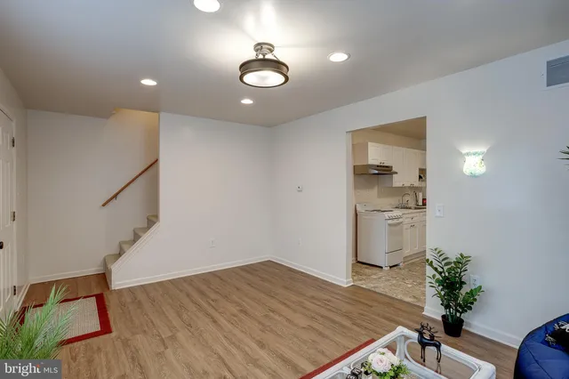 a view of a room with wooden floor and staircase