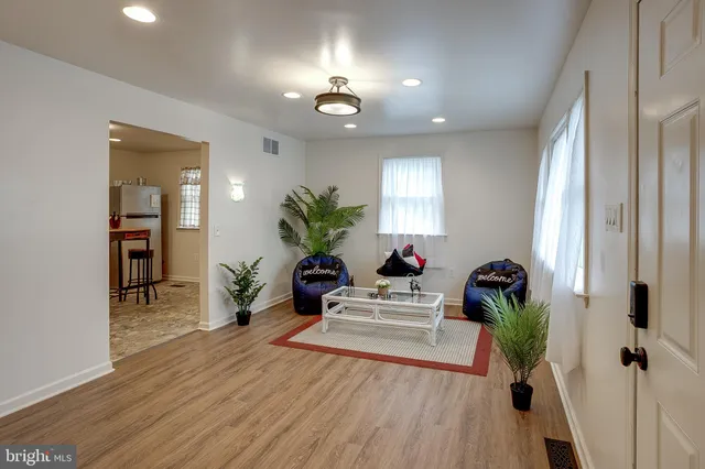 a living room with furniture and a potted plant