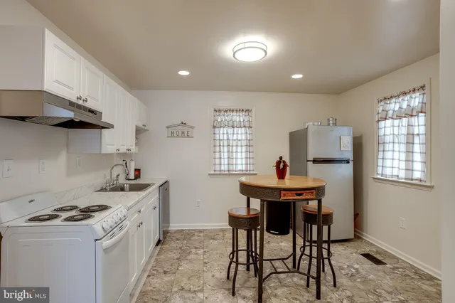 a kitchen that has a table and chairs in it