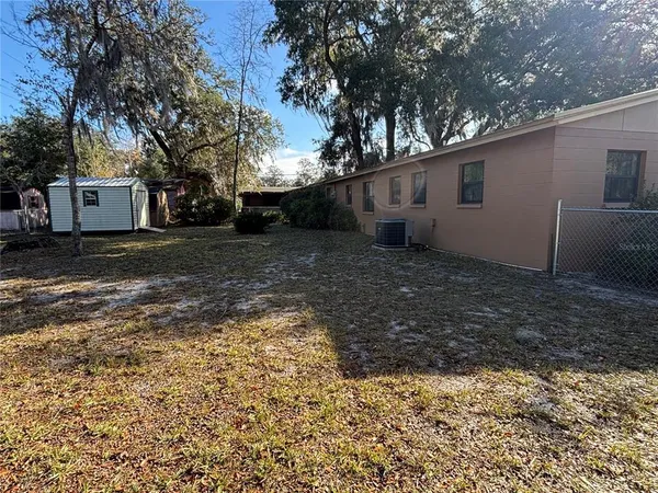 a view of a yard with a house and a tree