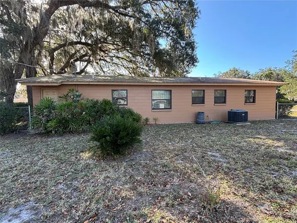 a view of house with backyard and garden