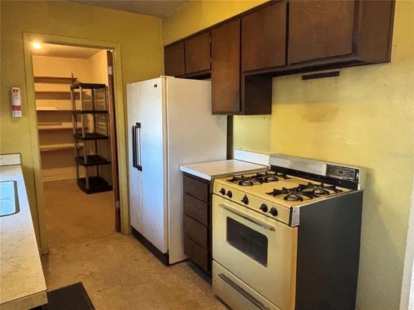a kitchen with a stove and a refrigerator