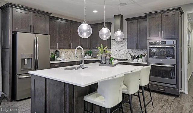 a kitchen with a table and refrigerator