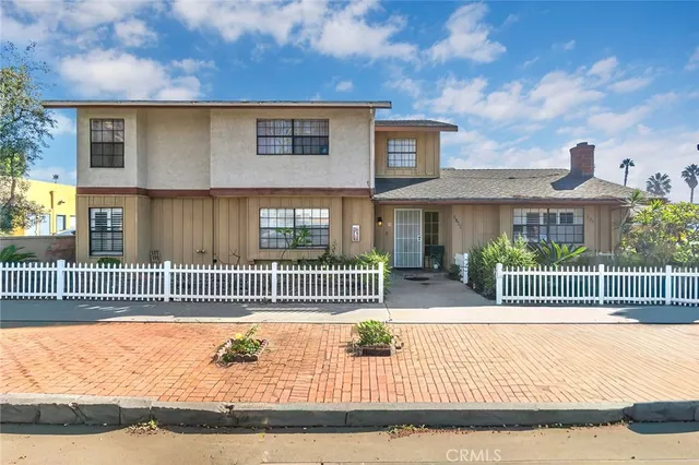 a view of a house with a iron fence