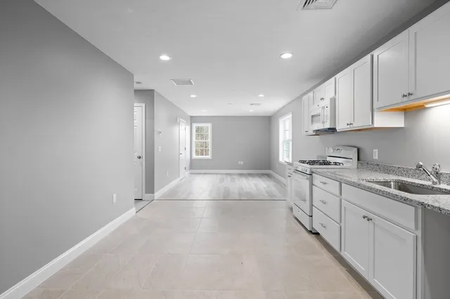 a view of a kitchen with electric appliances