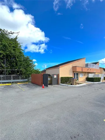 a view of a house with swimming pool and a yard