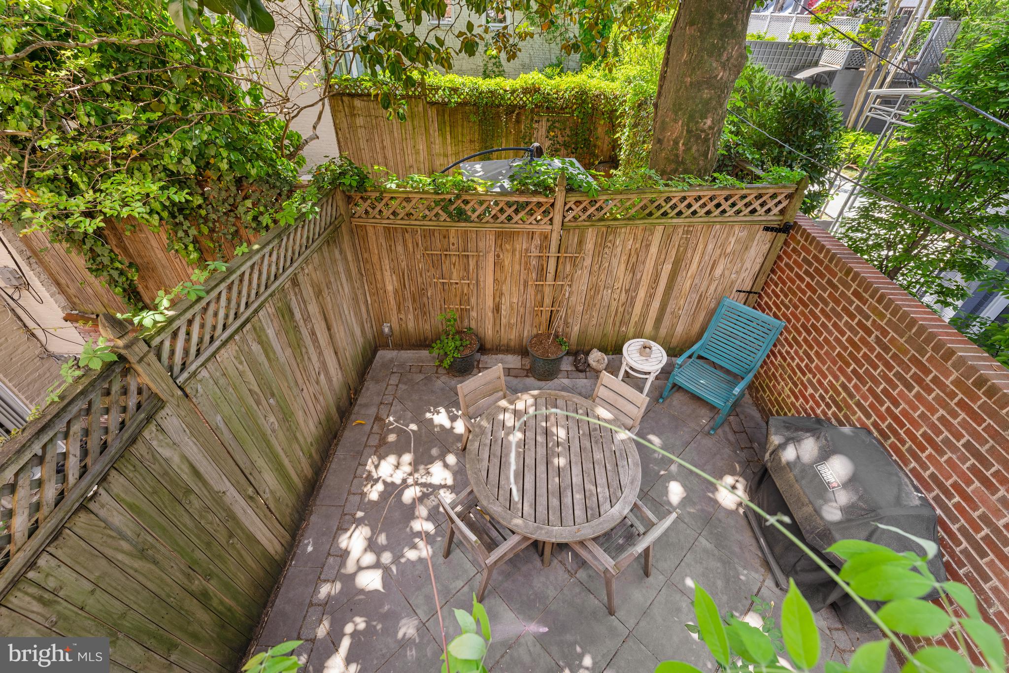 3104 N Street Northwest Washington, DC 20007 - Photo 11 of 25 a view of a patio with table and chairs with wooden floor and fence