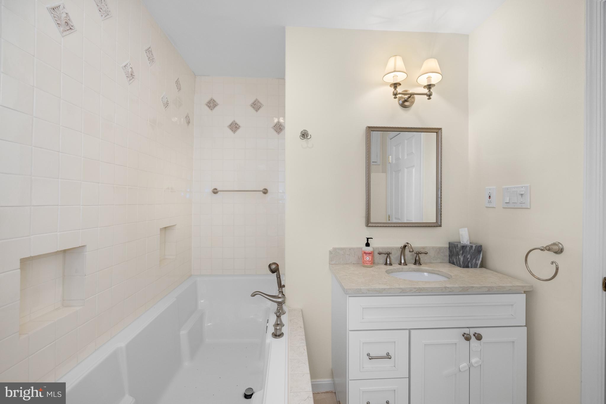 3104 N Street Northwest Washington, DC 20007 - Photo 15 of 25 a bathroom with a sink vanity and a mirror