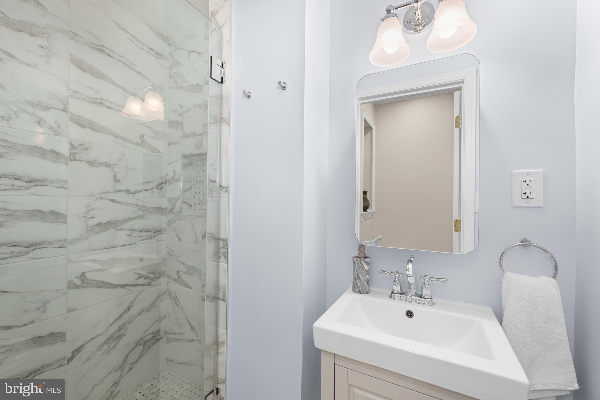 3104 N Street Northwest Washington, DC 20007 - Photo 19 of 25 a bathroom with a sink a mirror and shower