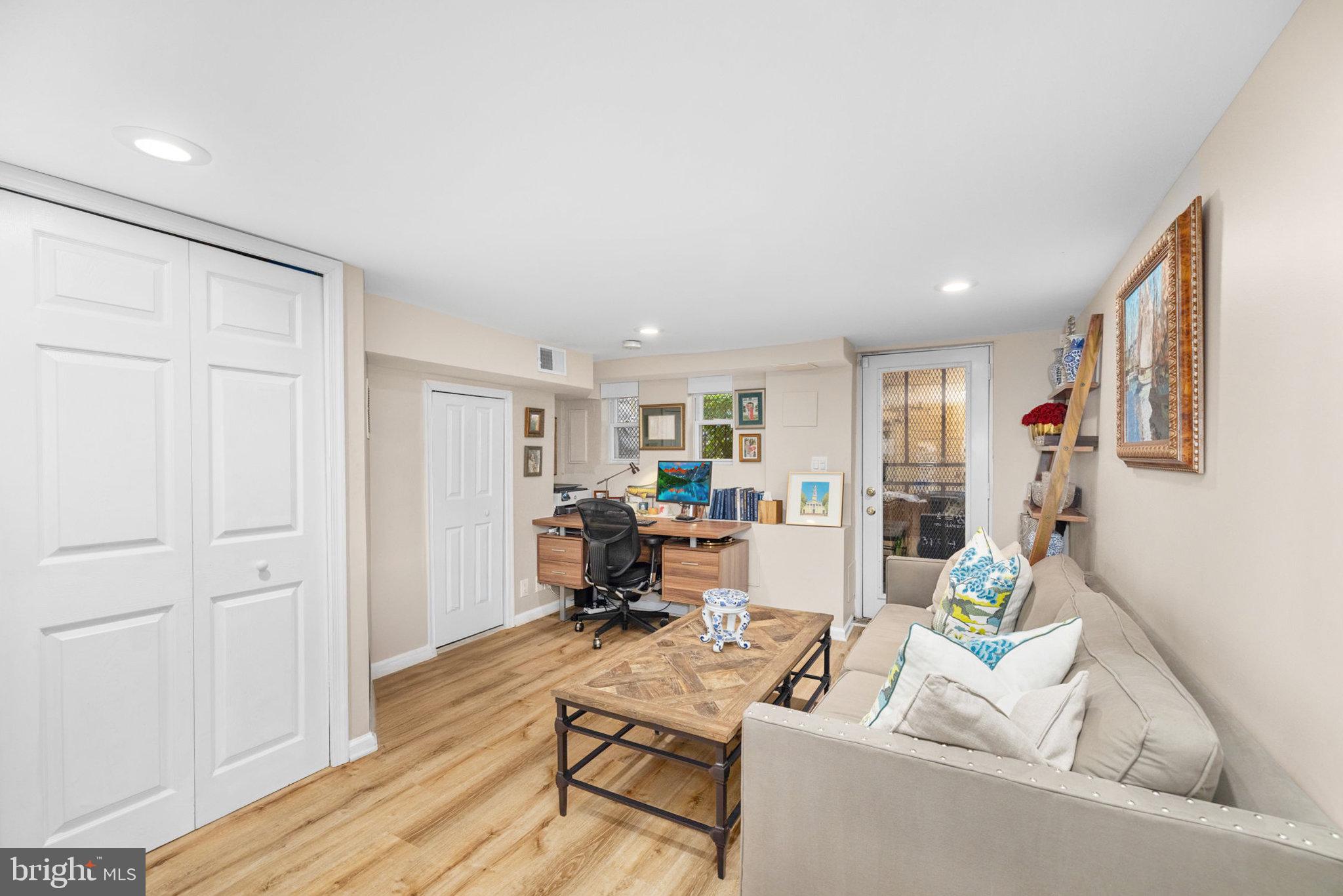 3104 N Street Northwest Washington, DC 20007 - Photo 20 of 25 a living room with furniture and a wooden floor