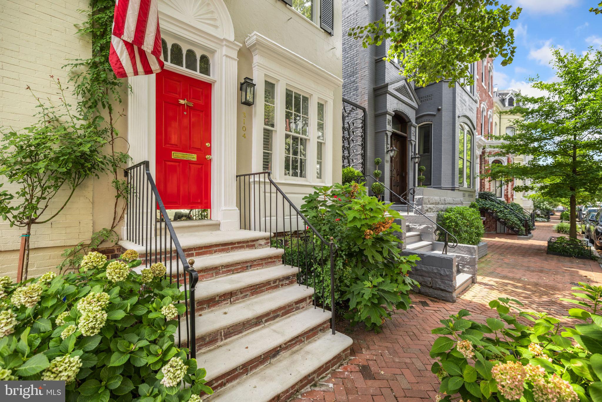 3104 N Street Northwest Washington, DC 20007 - Photo 2 of 25 a front view of a multi story residential apartment building with yard and sign board