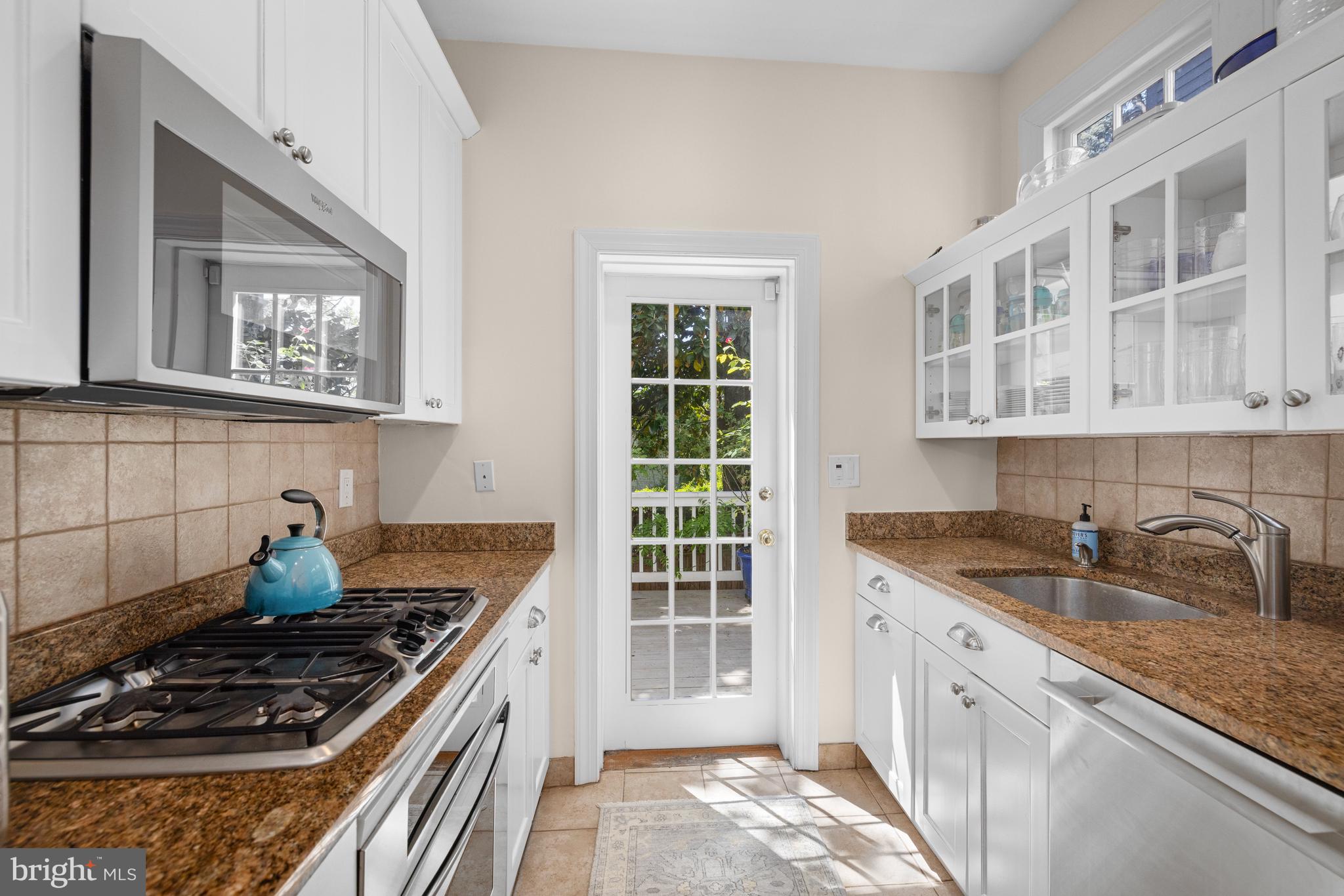 3104 N Street Northwest Washington, DC 20007 - Photo 9 of 25 a kitchen with stainless steel appliances granite countertop a stove and a sink