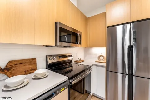 a kitchen with a refrigerator and a stove top oven