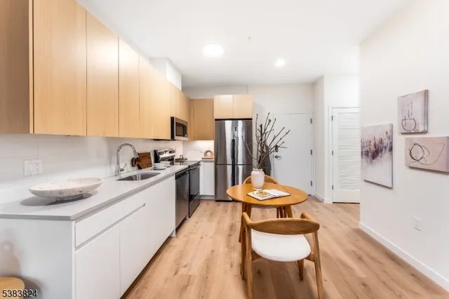 a kitchen with stainless steel appliances kitchen island granite countertop a sink and cabinets