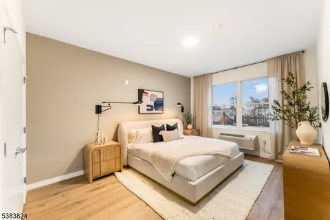 a bedroom with a large bed and a large window