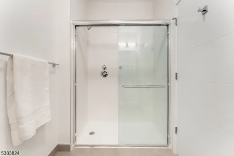 a bathroom with a glass shower door