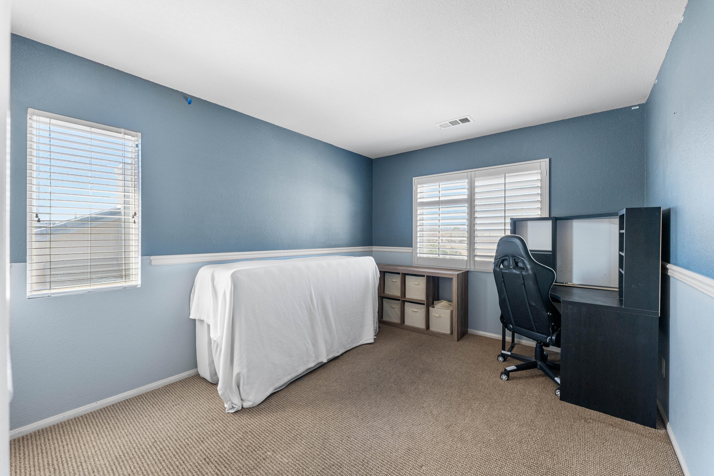 44225 Rucker Street Lancaster, CA 93535 - Photo 13 of 16 a bedroom with a bed and a desk