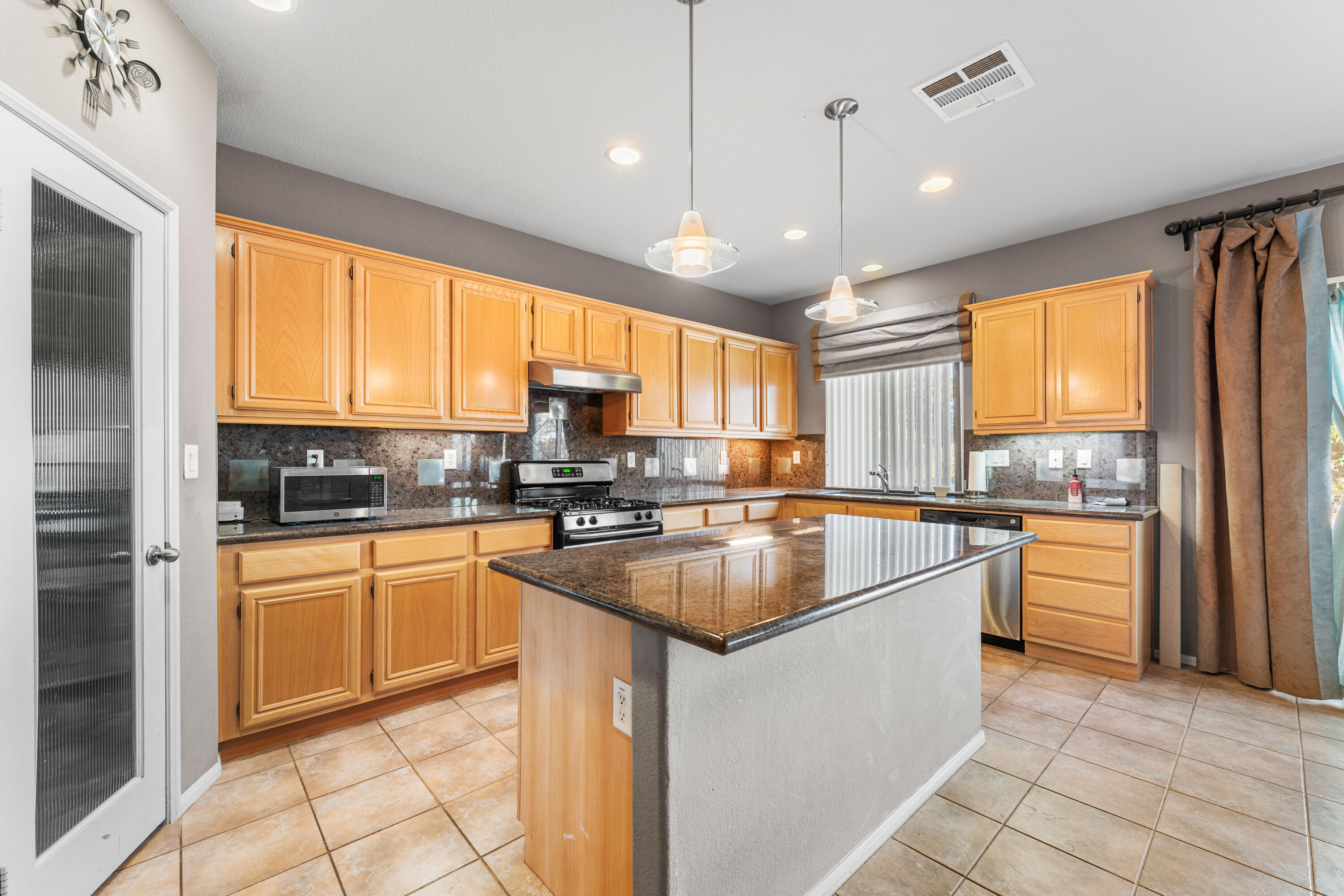 44225 Rucker Street Lancaster, CA 93535 - Photo 4 of 16 a kitchen with stainless steel appliances granite countertop a sink a stove and refrigerator