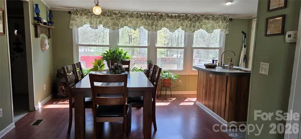 a dining room with furniture and wooden floor