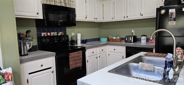a kitchen with stainless steel appliances granite countertop a refrigerator sink and cabinets