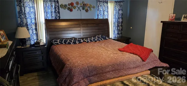a bed sitting in a bedroom next to a window
