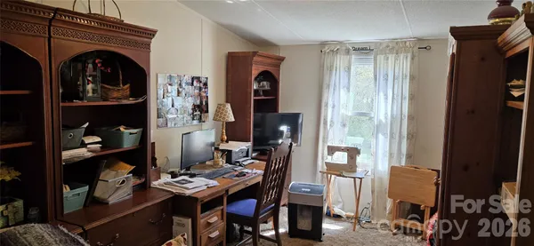 a view of a livingroom with furniture and bedroom
