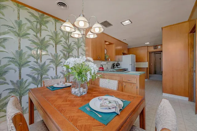 a table and chairs in a kitchen next to a window